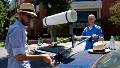 Research team installing the mobile air temperature measurement apparatus on a vehicle.